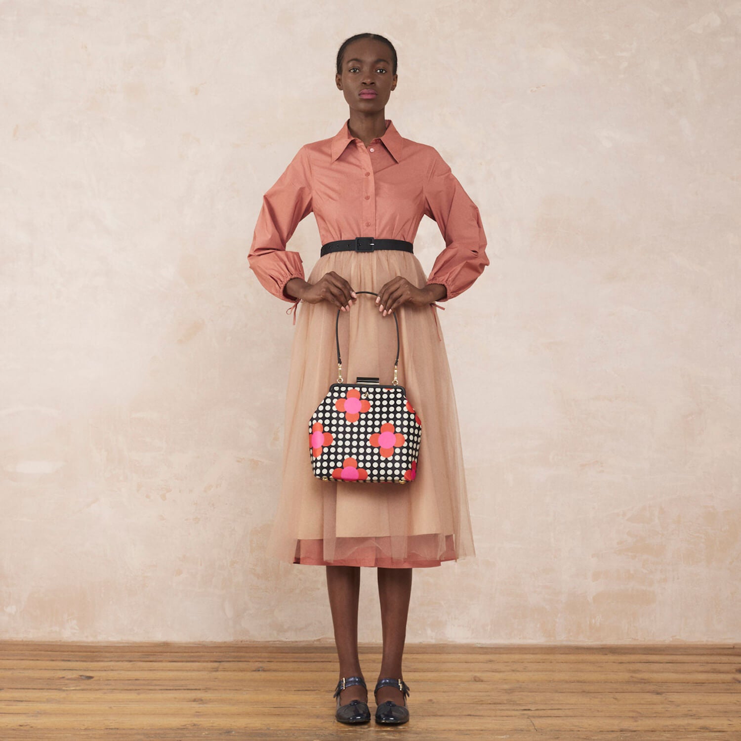 Model wearing the Jenny D Handbag in Fuchsia Flower Polka Dot pattern by Orla Kiely