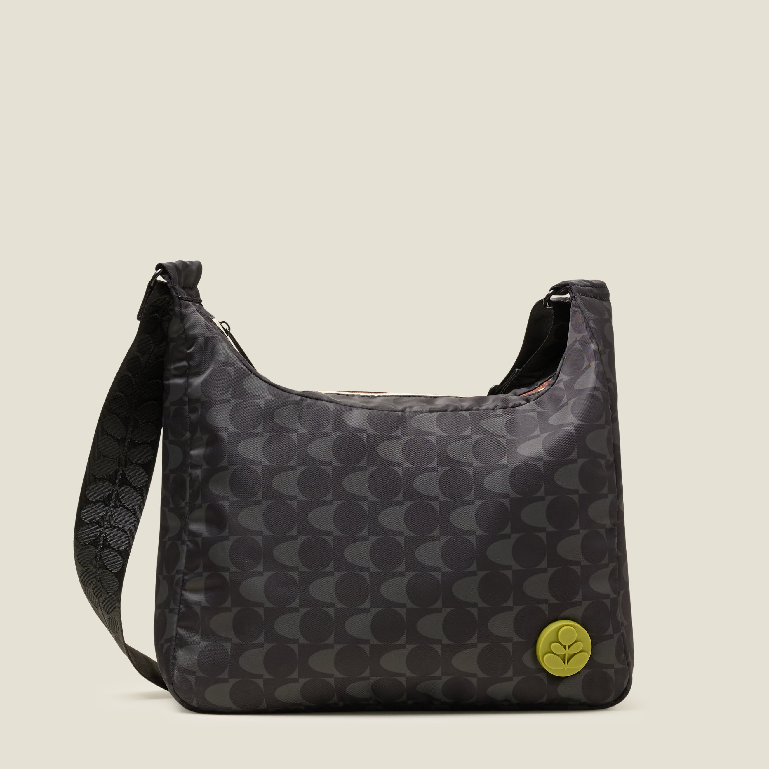 Front view of crossbody bag in a black and grey pattern. The handbag features a lime stem logo detail.