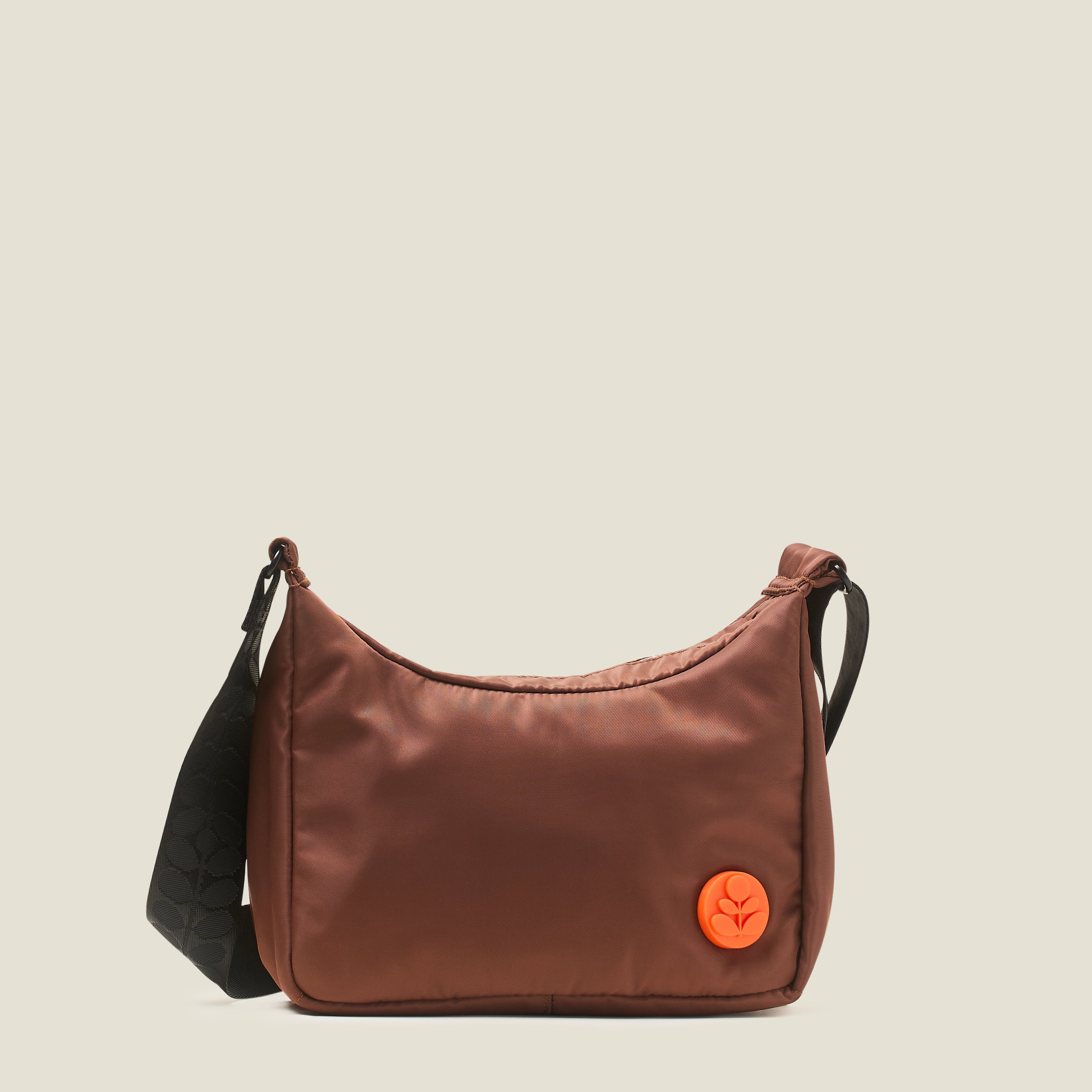 Front view of the Ratio Small bag in brown, a crossbody bag with an orange Orla Kiely logo.