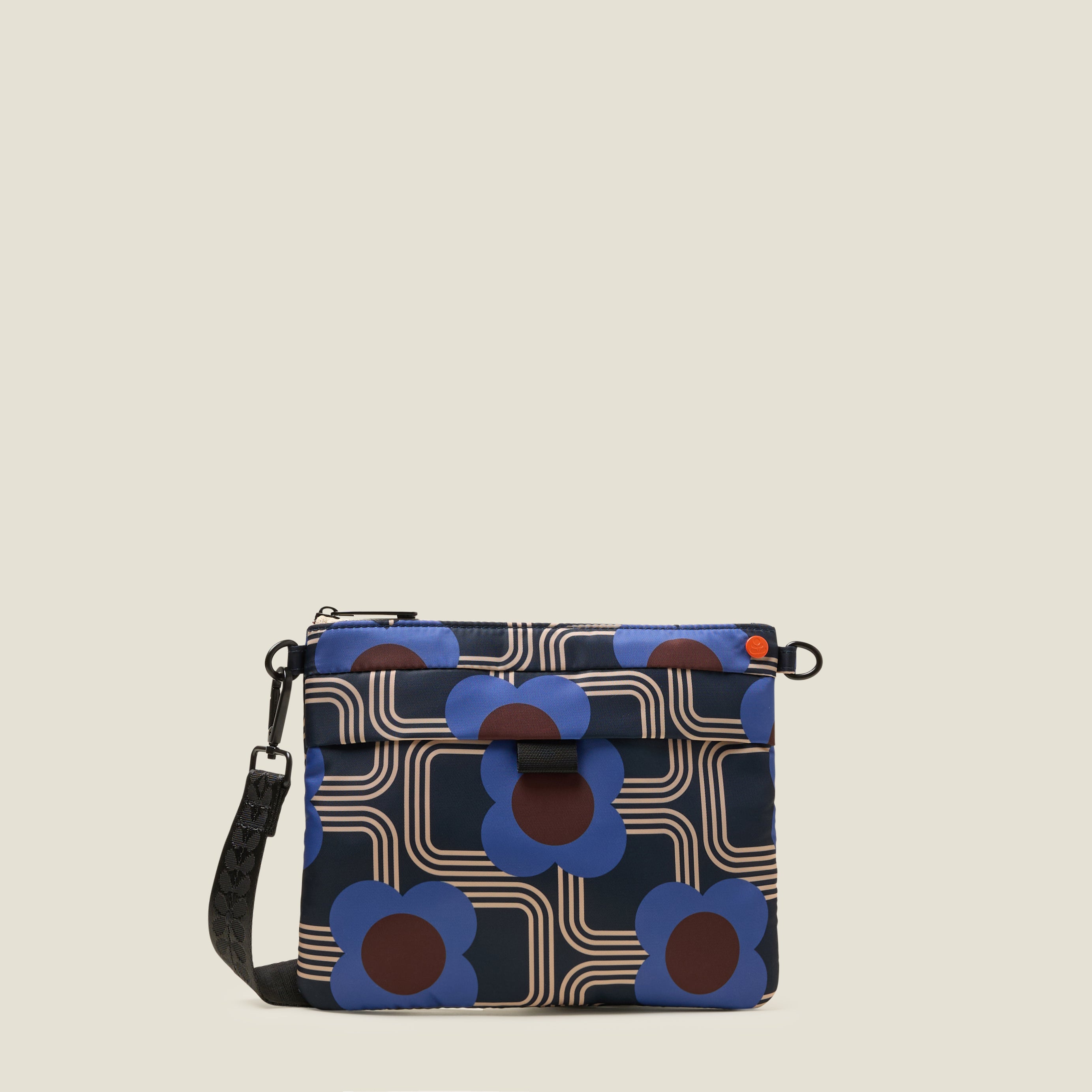 Patterned crossbody handbag with blue and brown retro floral design on a beige background