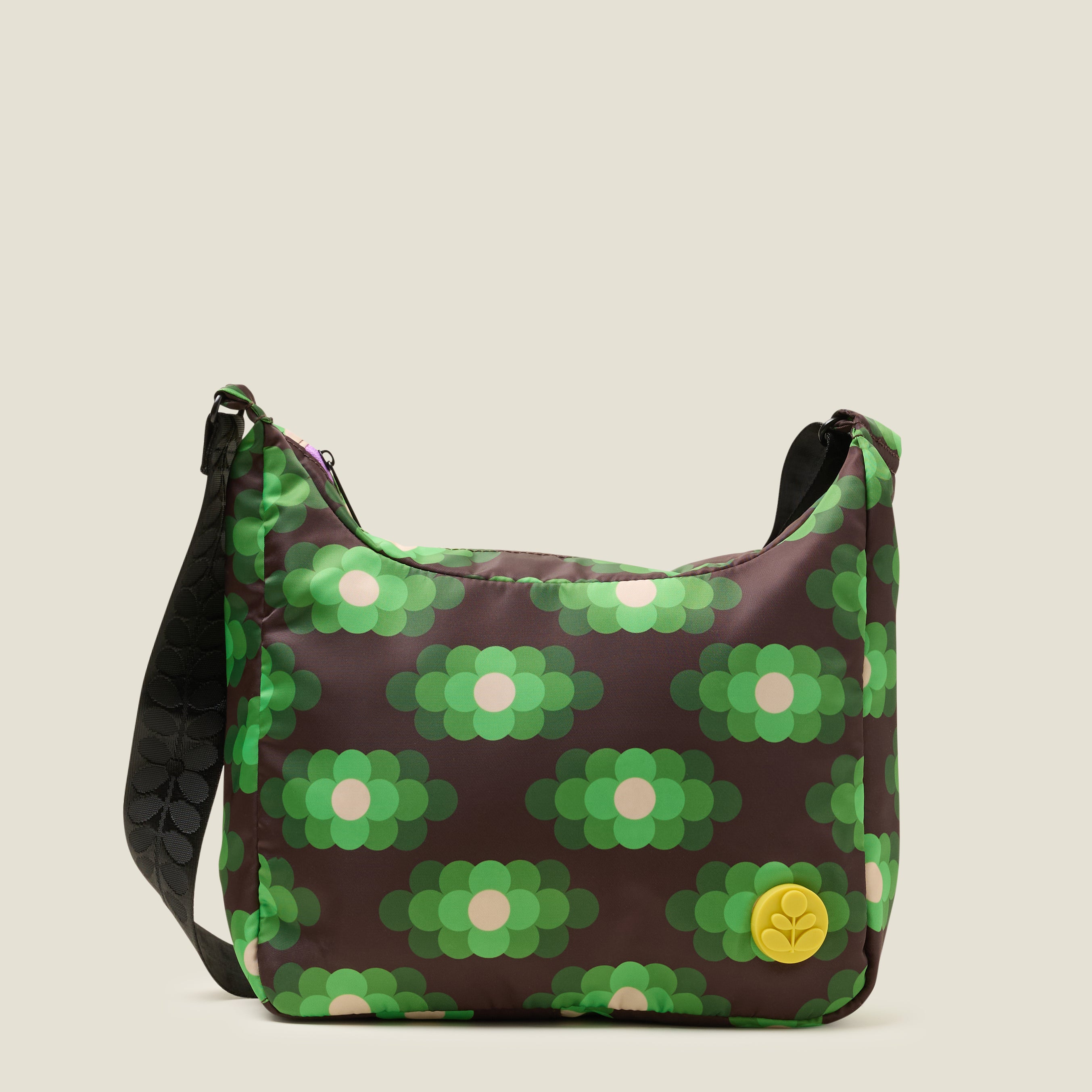 Front view of crossbody bag in a neon green floral pattern. The handbag features a yellow stem logo detail.