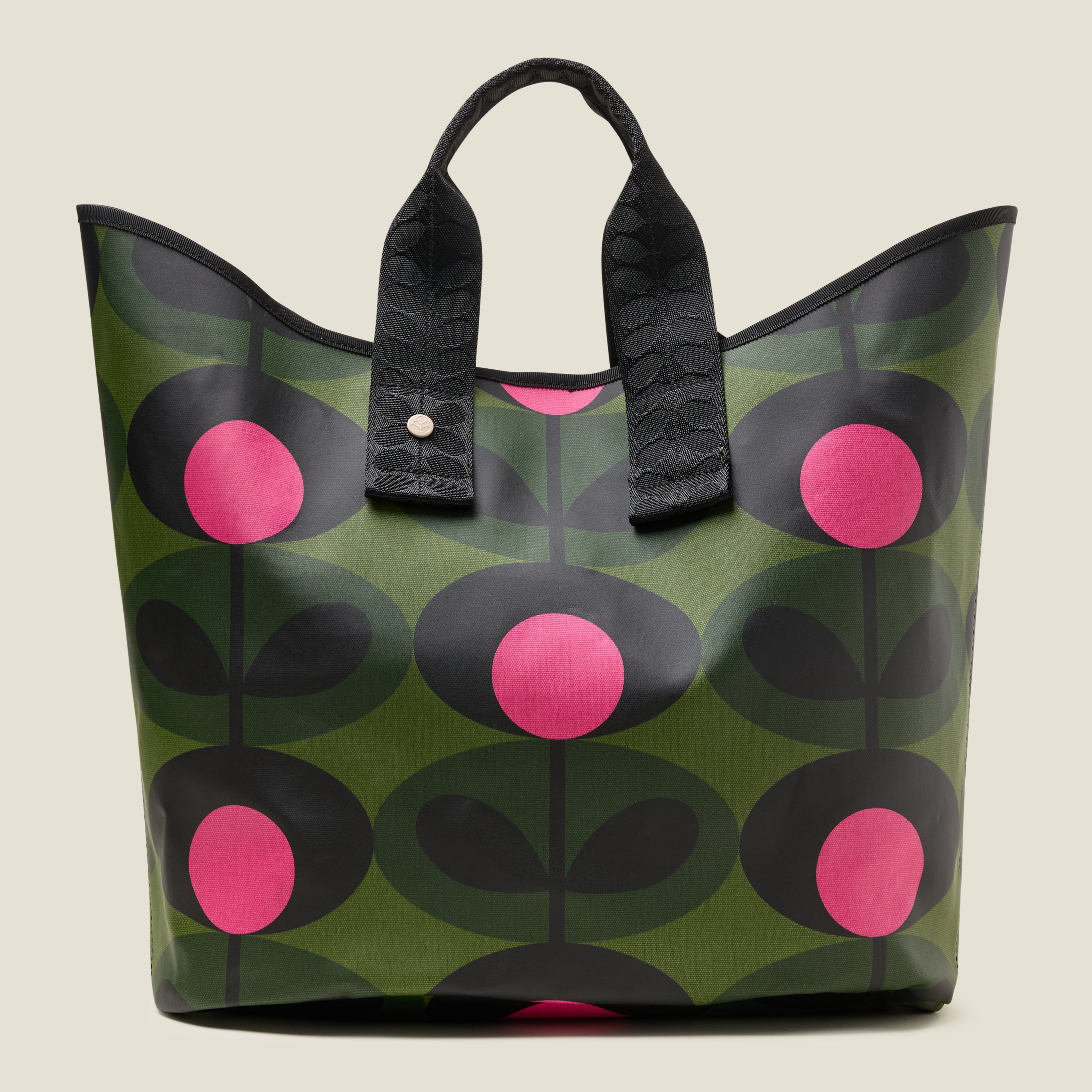 A women's large green tote bag with pink and black floral pattern with Orla Kiely webbing handles and shoulder strap.