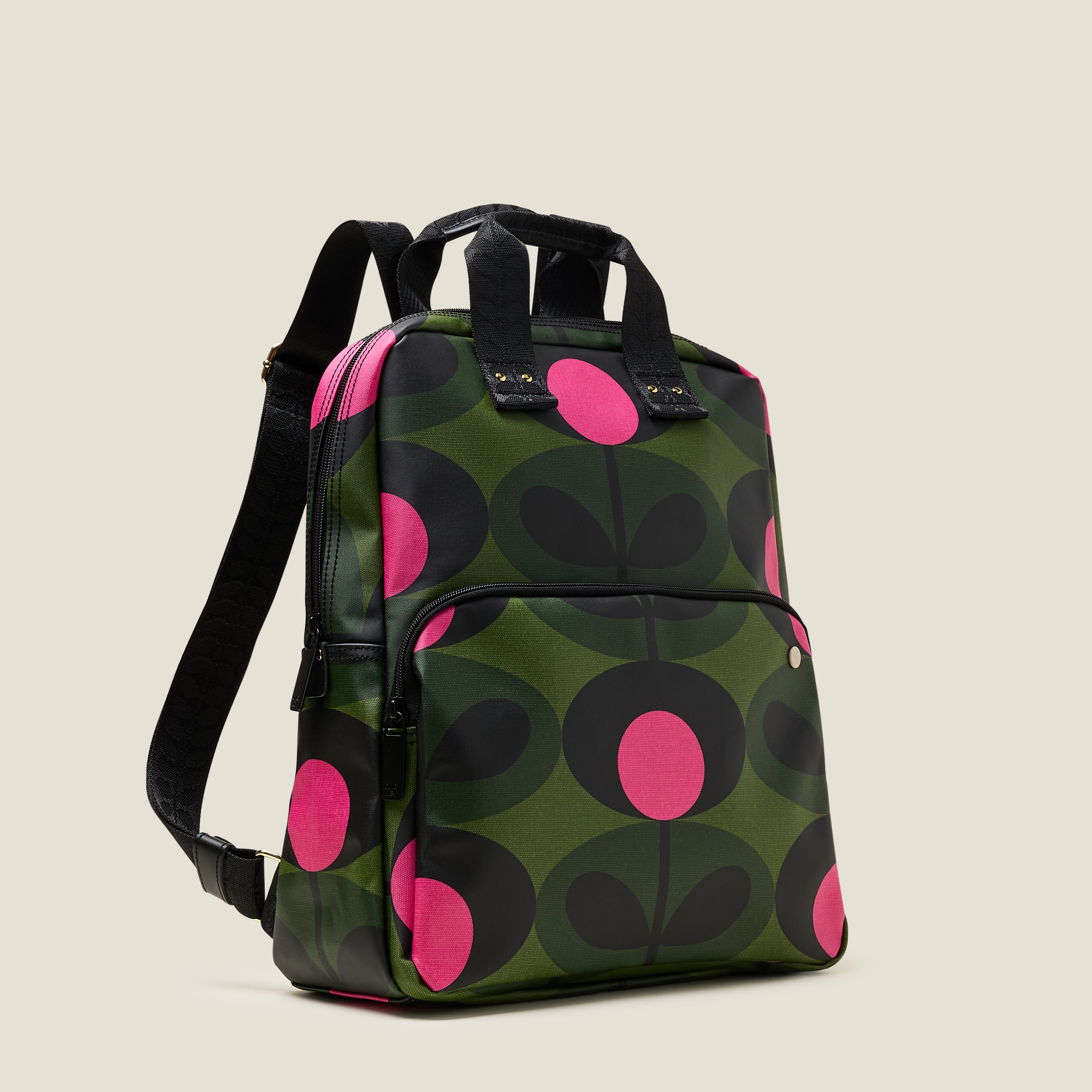 Side view of  the Lotta Backpack in a green stem print with bright pink dots, featuring a zipped front pocket, branded grab handles and adjustable shoulder straps.
