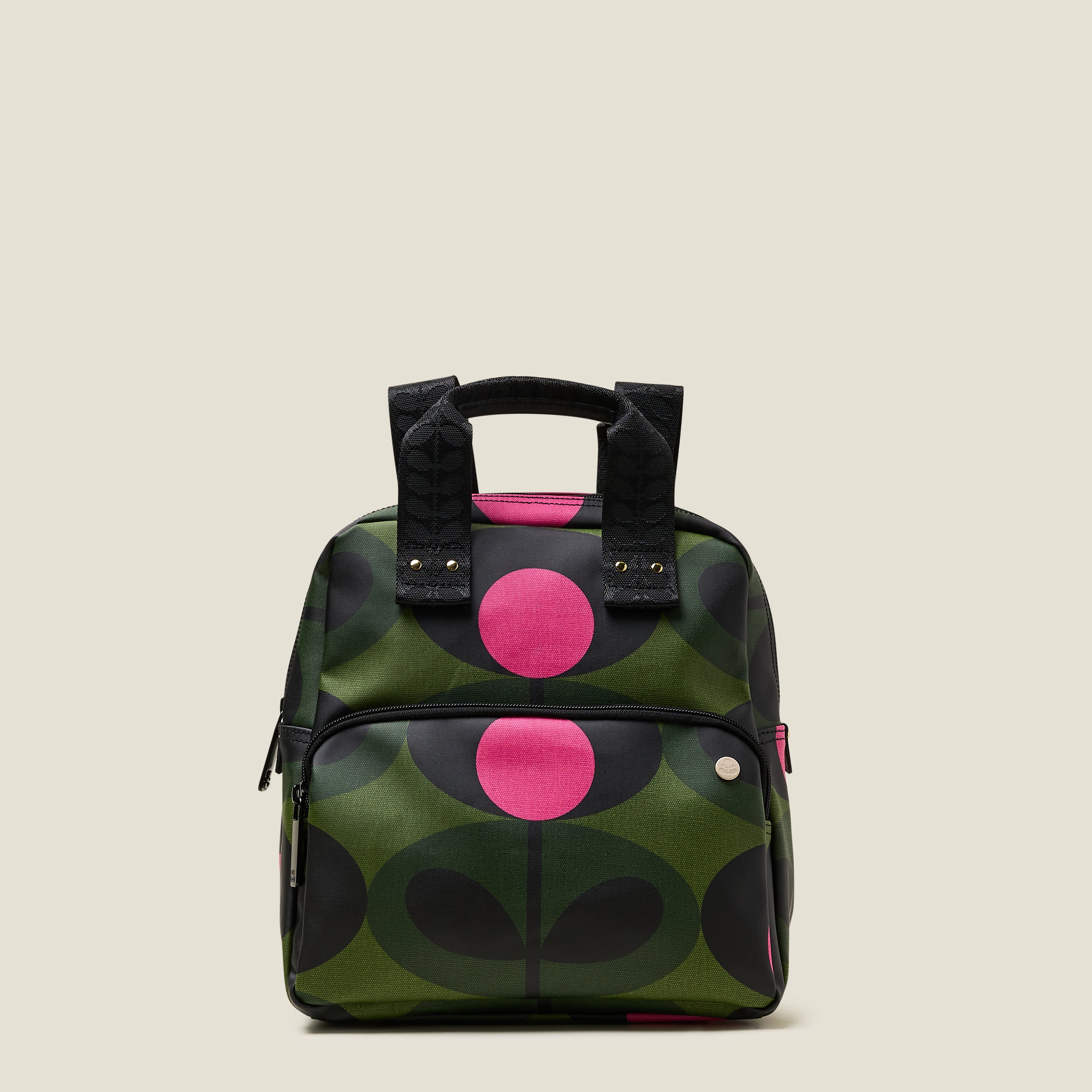Mini Lotta Backpack in a green stem print with bright pink dots, featuring a zipped front pocket and branded grab handles.