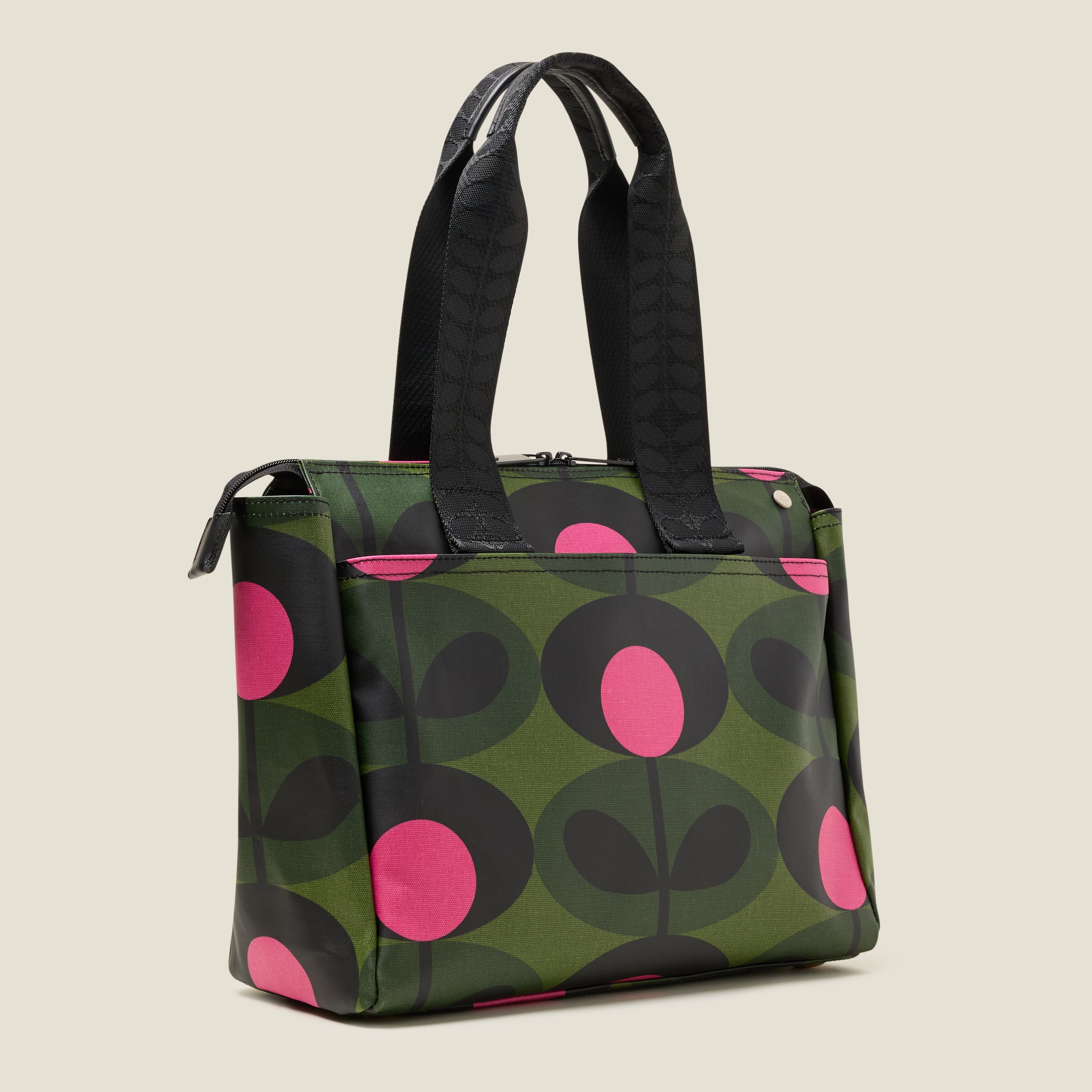 Side view of  tote bag with a green and pink stem pattern, featuring a slip pocket.