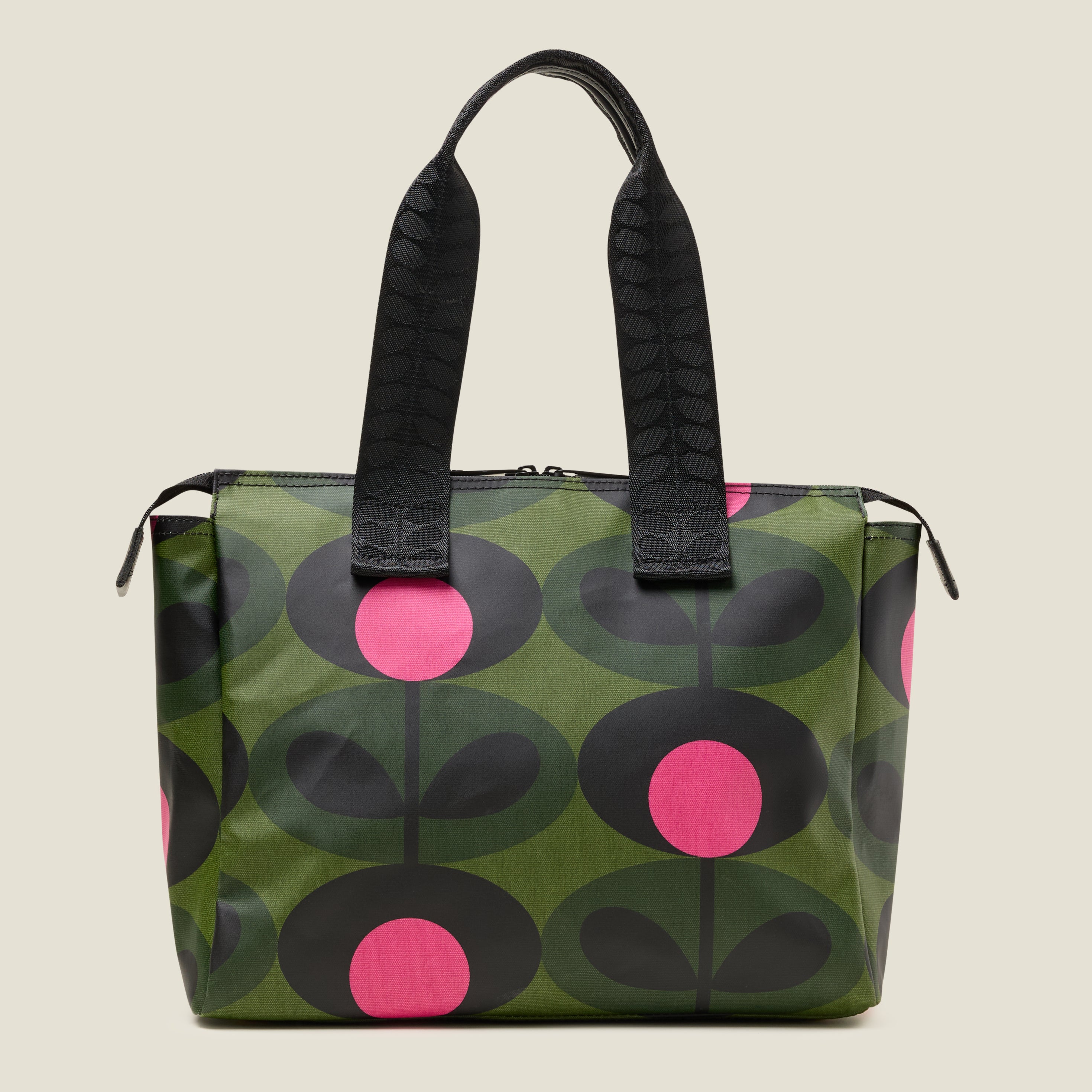 Back view of a tote bag with a green and pink stem pattern, with branded grab handles.