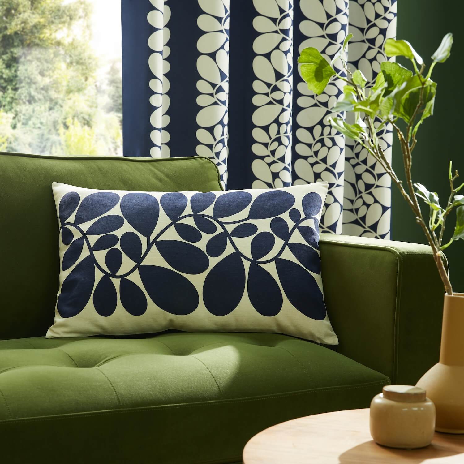 Orla Kiely sycamore stem blue and olive cushion on couch